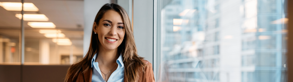 Gnesist tax planning post image is of a business women standing by window at an office.